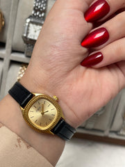 Golden charm black leather watch